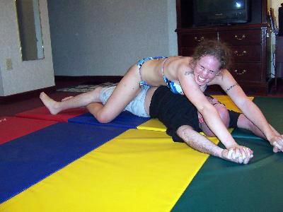 Nikita uses her long legs to stretch Greg